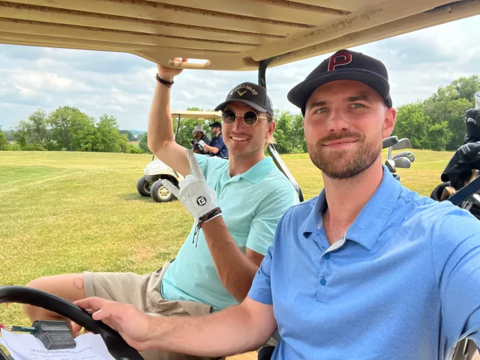 Austin cruising the course on a golf cart